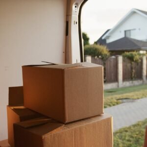 Mudanzas en Málaga. View inside a delivery van with stacked cardboard boxes ready for moving.